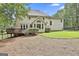 Backyard view of a home featuring a deck, large windows, and a well-maintained lawn at 230 Hedgewick Way, Tyrone, GA 30290