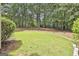 Beautifully manicured backyard with lush green lawn and mature trees at 230 Hedgewick Way, Tyrone, GA 30290