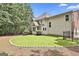 The home boasts a private backyard with green grass, mature trees, and perimeter landscaping at 230 Hedgewick Way, Tyrone, GA 30290