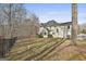 Expansive backyard featuring a well-maintained lawn and mature trees, surrounded by a sleek black fence at 230 Hedgewick Way, Tyrone, GA 30290