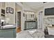 Elegant bathroom featuring double sink vanity, large marble floor tiles, and access to the walk-in closet at 230 Hedgewick Way, Tyrone, GA 30290