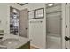 Bathroom with granite sink vanity, large mirror, and views to bathtub and home office at 230 Hedgewick Way, Tyrone, GA 30290