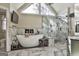 A luxurious bathroom features a soaking tub, a glass enclosed shower, and marble tiling at 230 Hedgewick Way, Tyrone, GA 30290