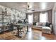 Home office boasts hardwood floors, ceiling fan and sofa with decorative pillows at 230 Hedgewick Way, Tyrone, GA 30290