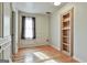 Spacious bedroom features hardwood floors, natural light, and custom built-in shelves at 230 Hedgewick Way, Tyrone, GA 30290
