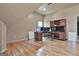 Bonus room features hardwood floors, desk, and built-in wood media cabinet at 230 Hedgewick Way, Tyrone, GA 30290