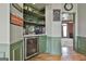 Butler pantry with beverage fridge, and storage shelves with stone backsplash and a view into the dining room at 230 Hedgewick Way, Tyrone, GA 30290
