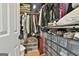 Walk-in closet with organized storage, including shelves, hanging rods, and clear shoe containers at 230 Hedgewick Way, Tyrone, GA 30290