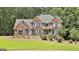 Charming two-story brick home with blue shutters, manicured lawn, and inviting curb appeal at 230 Hedgewick Way, Tyrone, GA 30290