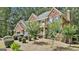 Beautiful brick home with blue shutters and a lush, landscaped front yard with mature trees at 230 Hedgewick Way, Tyrone, GA 30290