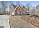 Beautiful two-story brick home with three-car garage and long driveway at 230 Hedgewick Way, Tyrone, GA 30290