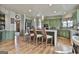 Open concept kitchen with a center island, barstool seating, stainless appliances and hardwood floors at 230 Hedgewick Way, Tyrone, GA 30290