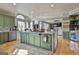 Kitchen island with stone countertop, seating, cooktop and view of the dining and living rooms at 230 Hedgewick Way, Tyrone, GA 30290