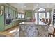 Spacious kitchen with granite island, pendant lighting, stainless appliances and hardwood floors at 230 Hedgewick Way, Tyrone, GA 30290