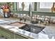 Modern kitchen sink with a stainless faucet, granite countertops and a decorative tiled backsplash at 230 Hedgewick Way, Tyrone, GA 30290
