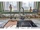 Kitchen sink details featuring granite countertops and modern fixtures under a window at 230 Hedgewick Way, Tyrone, GA 30290