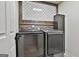 Laundry room features side-by-side, front-loading washer and dryer at 230 Hedgewick Way, Tyrone, GA 30290