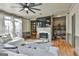 Cozy living room featuring a fireplace, built-in shelving, area rug, and a large sectional sofa at 230 Hedgewick Way, Tyrone, GA 30290