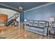 Formal living room boasts blue walls, hardwood floors, and a large archway leading to the foyer at 230 Hedgewick Way, Tyrone, GA 30290