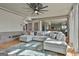 Open-concept living room flows into the kitchen, featuring hardwood floors and neutral tones at 230 Hedgewick Way, Tyrone, GA 30290