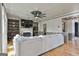 Comfortable living room featuring a fan, fire place, shelving, and hardwood floors at 230 Hedgewick Way, Tyrone, GA 30290