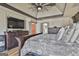 Spacious main bedroom with tray ceiling, large bed, sitting area, and ensuite bathroom access at 230 Hedgewick Way, Tyrone, GA 30290