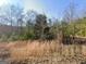 Overgrown lot with tall grass and trees at 8025 Creekwood Dr, Fairburn, GA 30213