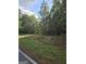 Wooded lot next to a paved road at 8025 Creekwood Dr, Fairburn, GA 30213