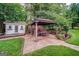 Backyard features a stone patio with gazebo, outdoor furniture, and well maintained garden at 3170 Ebenezer Rd, Marietta, GA 30066