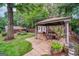 Backyard featuring a stone patio with gazebo and furniture, and green grass at 3170 Ebenezer Rd, Marietta, GA 30066
