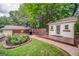 Charming backyard features lush greenery, outdoor grill and detached workshop with deck at 3170 Ebenezer Rd, Marietta, GA 30066