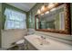 Bathroom featuring a vanity sink, toilet, window, and a shower tub combination at 3170 Ebenezer Rd, Marietta, GA 30066
