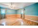 Spacious bedroom with hardwood floors, ceiling fan, and natural light from two windows at 3170 Ebenezer Rd, Marietta, GA 30066