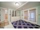 Bonus room featuring walk out doors, access to lower level and closet storage at 3170 Ebenezer Rd, Marietta, GA 30066