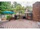 Large deck with blue umbrella, grill, and bench seating for outdoor relaxation and entertainment at 3170 Ebenezer Rd, Marietta, GA 30066