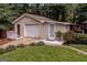 Detached garage with a white door, side entrance, and well-maintained landscaping at 3170 Ebenezer Rd, Marietta, GA 30066
