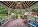 Charming gazebo interior featuring a ceiling fan, seating and views of the landscaped yard at 3170 Ebenezer Rd, Marietta, GA 30066
