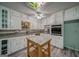 Traditional kitchen featuring white cabinets, granite counters, and a colorful stained glass skylight at 3170 Ebenezer Rd, Marietta, GA 30066