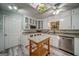 Bright kitchen with white cabinets, granite countertops, and stainless steel appliances at 3170 Ebenezer Rd, Marietta, GA 30066