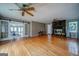 Bright living room boasting hardwood floors, stone fireplace, and access to the sunroom through sliding doors at 3170 Ebenezer Rd, Marietta, GA 30066