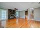 Spacious living room with a stone fireplace, hardwood flooring, and staircase leading to upper level at 3170 Ebenezer Rd, Marietta, GA 30066