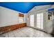 Bright sun room with brick accents, white floors and door to backyard at 3170 Ebenezer Rd, Marietta, GA 30066