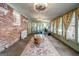 Bright sunroom with brick accent wall, multiple windows, and ceiling fan at 3170 Ebenezer Rd, Marietta, GA 30066