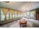 Cozy sunroom featuring many windows, a ceiling fan, and neutral carpet at 3170 Ebenezer Rd, Marietta, GA 30066