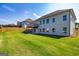 House features a large backyard with grassy area at 65 Oakhurst Trl, Sharpsburg, GA 30277