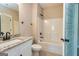 Clean bathroom with a shower/tub combo and granite vanity at 65 Oakhurst Trl, Sharpsburg, GA 30277