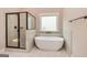 Bathroom featuring a soaking tub, walk-in shower, and tile floors at 65 Oakhurst Trl, Sharpsburg, GA 30277