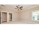 Bright bedroom featuring a ceiling fan and ample natural light at 65 Oakhurst Trl, Sharpsburg, GA 30277