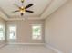 Bright bedroom with carpeted floor, ceiling fan, and large windows at 65 Oakhurst Trl, Sharpsburg, GA 30277