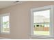 Bedroom with two windows and neutral color scheme at 65 Oakhurst Trl, Sharpsburg, GA 30277